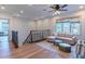 Upstairs living room features stylish seating, a ceiling fan, and views from a large picture window at 4306 E Flower St, Phoenix, AZ 85018