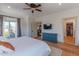Sunlit main bedroom leads to a private balcony, with a large closet and hardwood floors at 4306 E Flower St, Phoenix, AZ 85018