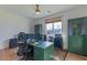 Bright home office with natural light, green accents, and a functional work space at 4306 E Flower St, Phoenix, AZ 85018