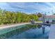 Inviting pool area reflecting sky and trees with ample space for relaxation and privacy at 4306 E Flower St, Phoenix, AZ 85018