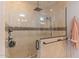 Luxurious walk-in shower features beige tile surround and mosaic accents, with modern fixtures at 4306 E Flower St, Phoenix, AZ 85018