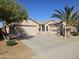 Charming single-story home showcasing a three-car garage, desert landscaping, and a welcoming entrance at 43486 W Mccord Dr, Maricopa, AZ 85138