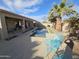 Backyard pool boasts a covered patio and lush landscaping with palm trees at 43486 W Mccord Dr, Maricopa, AZ 85138