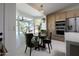 Bright breakfast nook featuring a large window and stylish green velvet chairs at 4528 E Sunnyside Ln, Phoenix, AZ 85032