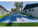 Outdoor sport court featuring blue flooring with white lines, a tall net, and green turf surrounding at 4528 E Sunnyside Ln, Phoenix, AZ 85032