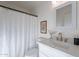 Bright bathroom with a vanity featuring a marble countertop, painting, and a shower with curtain at 4731 N 26Th Ln, Phoenix, AZ 85017