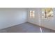 Light-filled bedroom features plush carpeting, baseboard trim, neutral paint, and double-paned windows at 4731 N 26Th Ln, Phoenix, AZ 85017
