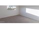 Empty bedroom features neutral carpet and a large window for natural light at 4731 N 26Th Ln, Phoenix, AZ 85017