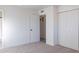 Bright bedroom featuring neutral carpet, a closet, and an open closet for storage at 4731 N 26Th Ln, Phoenix, AZ 85017