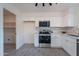 Bright kitchen with stainless steel appliances, white cabinets, tile backsplash, and pantry access at 4731 N 26Th Ln, Phoenix, AZ 85017