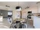 Bright kitchen with stainless steel appliances, white cabinets, tile backsplash, and adjacent dining area at 4731 N 26Th Ln, Phoenix, AZ 85017