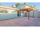 View of the backyard brick patio with the sliding glass door and pergola with a backyard at 4731 N 26Th Ln, Phoenix, AZ 85017