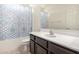 Bathroom featuring a tub with patterned shower curtain and a spacious mirror at 5345 W Leodra Ln, Laveen, AZ 85339