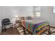 Cozy bedroom featuring a colorful bedspread, wood floors, and natural light at 5345 W Leodra Ln, Laveen, AZ 85339