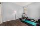 Bright bedroom with a treadmill, bench, and weights, creating a convenient home gym space at 5345 W Leodra Ln, Laveen, AZ 85339