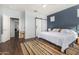 A bedroom with a bed and an ensuite bathroom, featuring a barn door entrance at 5345 W Leodra Ln, Laveen, AZ 85339