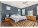 A bedroom with a large bed, a dresser with mirror and natural light from three windows at 5345 W Leodra Ln, Laveen, AZ 85339