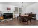 Well-lit dining area with a modern chandelier, piano, and minimalist decor at 5345 W Leodra Ln, Laveen, AZ 85339
