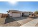 Lovely home boasting desert landscaping, a brick driveway, and a two-car garage at 5345 W Leodra Ln, Laveen, AZ 85339