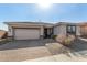 Charming single-story home featuring a brick driveway, neutral stucco, and a two-car garage at 5345 W Leodra Ln, Laveen, AZ 85339