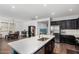 Spacious kitchen featuring a center island, dark cabinets, and open layout to the dining area at 5345 W Leodra Ln, Laveen, AZ 85339
