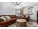Comfortable living room showcasing leather seating, a modern fan, and a neutral color scheme at 5345 W Leodra Ln, Laveen, AZ 85339