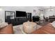 Inviting living room featuring a large entertainment center, piano, and ample seating space at 5345 W Leodra Ln, Laveen, AZ 85339