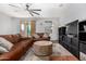 Cozy living room featuring a fan, leather sofas, and neutral decor at 5345 W Leodra Ln, Laveen, AZ 85339