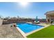 Backyard oasis with a sparkling pool, lounge chairs, and easy-to-maintain desert landscaping at 5345 W Leodra Ln, Laveen, AZ 85339