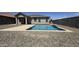 View of the pool with the house in the background, seamlessly blending indoor and outdoor living at 5345 W Leodra Ln, Laveen, AZ 85339