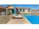 Beautiful pool with nearby lounge chairs, patio, and outdoor dining area at 5345 W Leodra Ln, Laveen, AZ 85339