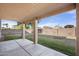 A large, green backyard with a covered patio and block wall at 5422 W Bryce Ln, Glendale, AZ 85301
