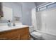 Bathroom featuring a vanity, toilet, mirror, and bathtub with white shower curtain at 5422 W Bryce Ln, Glendale, AZ 85301