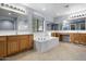 Bathroom featuring a soaking tub, double sinks, and wood cabinets at 5422 W Bryce Ln, Glendale, AZ 85301