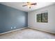 Cozy bedroom with neutral carpet, a ceiling fan, and a window providing natural light at 5422 W Bryce Ln, Glendale, AZ 85301