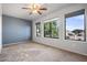 Bright bedroom featuring plush carpeting and large windows at 5422 W Bryce Ln, Glendale, AZ 85301