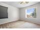 Bedroom with neutral carpet and a large window that lets in natural light at 5422 W Bryce Ln, Glendale, AZ 85301