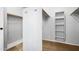 Walk-in closet with built-in shelving, rods, and carpeted floor at 5422 W Bryce Ln, Glendale, AZ 85301