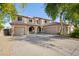 Inviting two-story home showcasing a three-car garage and a charming front entrance with arched accents at 5422 W Bryce Ln, Glendale, AZ 85301