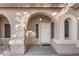 Charming front entrance with arched doorway and stucco exterior details at 5422 W Bryce Ln, Glendale, AZ 85301