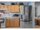 Stainless steel refrigerator and ample cabinet space in this bright, modern kitchen at 5422 W Bryce Ln, Glendale, AZ 85301