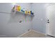 Functional laundry room with shelving for storage and utility connections at 5422 W Bryce Ln, Glendale, AZ 85301