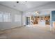 Bright, open-concept living room flows into kitchen with stainless steel appliances and lots of light at 5422 W Bryce Ln, Glendale, AZ 85301