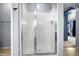 Bathroom shower with glass door and neutral tile at 5422 W Bryce Ln, Glendale, AZ 85301