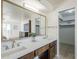 Bathroom with double sink vanity, large mirror, and walk-in closet at 5833 E Butte St, Mesa, AZ 85205