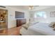 Bright bedroom featuring a window with views of neighborhood, hardwood floors and a dresser at 5833 E Butte St, Mesa, AZ 85205