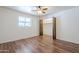 Neutral bedroom with hardwood floors, a ceiling fan, and a closet at 5833 E Butte St, Mesa, AZ 85205