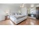 Bright main bedroom featuring hardwood floors, ceiling fan, and ensuite bathroom at 5833 E Butte St, Mesa, AZ 85205