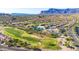 Aerial view displaying golf course, pool, tennis courts, community center, and mountain views at 6353 S Eagle Ct, Gold Canyon, AZ 85118