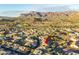 Aerial view of home and community featuring mountain views and a nearby golf course at 6353 S Eagle Ct, Gold Canyon, AZ 85118